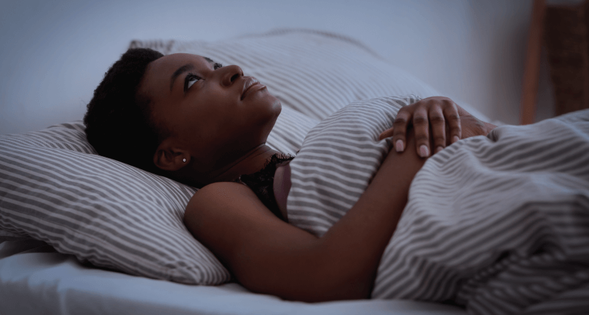 Woman laying awake in bed