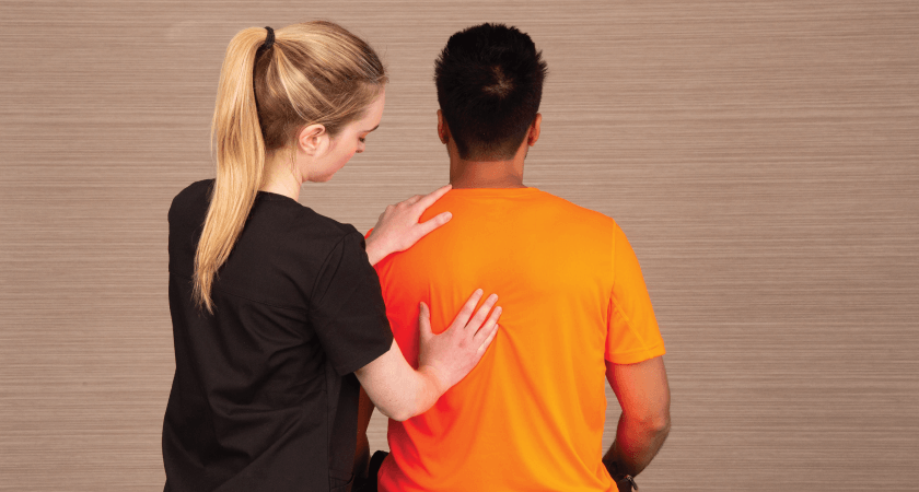 female chiropractor performing a wellness check on a male patient