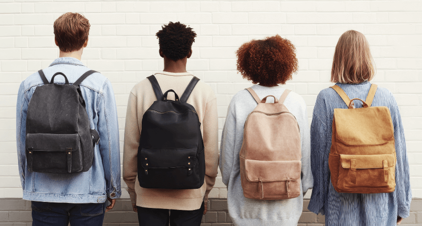 Teenagers demonstrating proper backpack wear for spine safety
