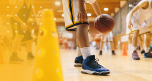 Close-up of a young basketball player's feet during practice, representing youth sports and active training.