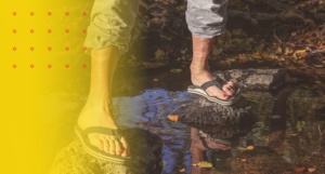 erson standing in water wearing flip-flops, illustrating how unsupportive footwear can impact posture and cause back pain.